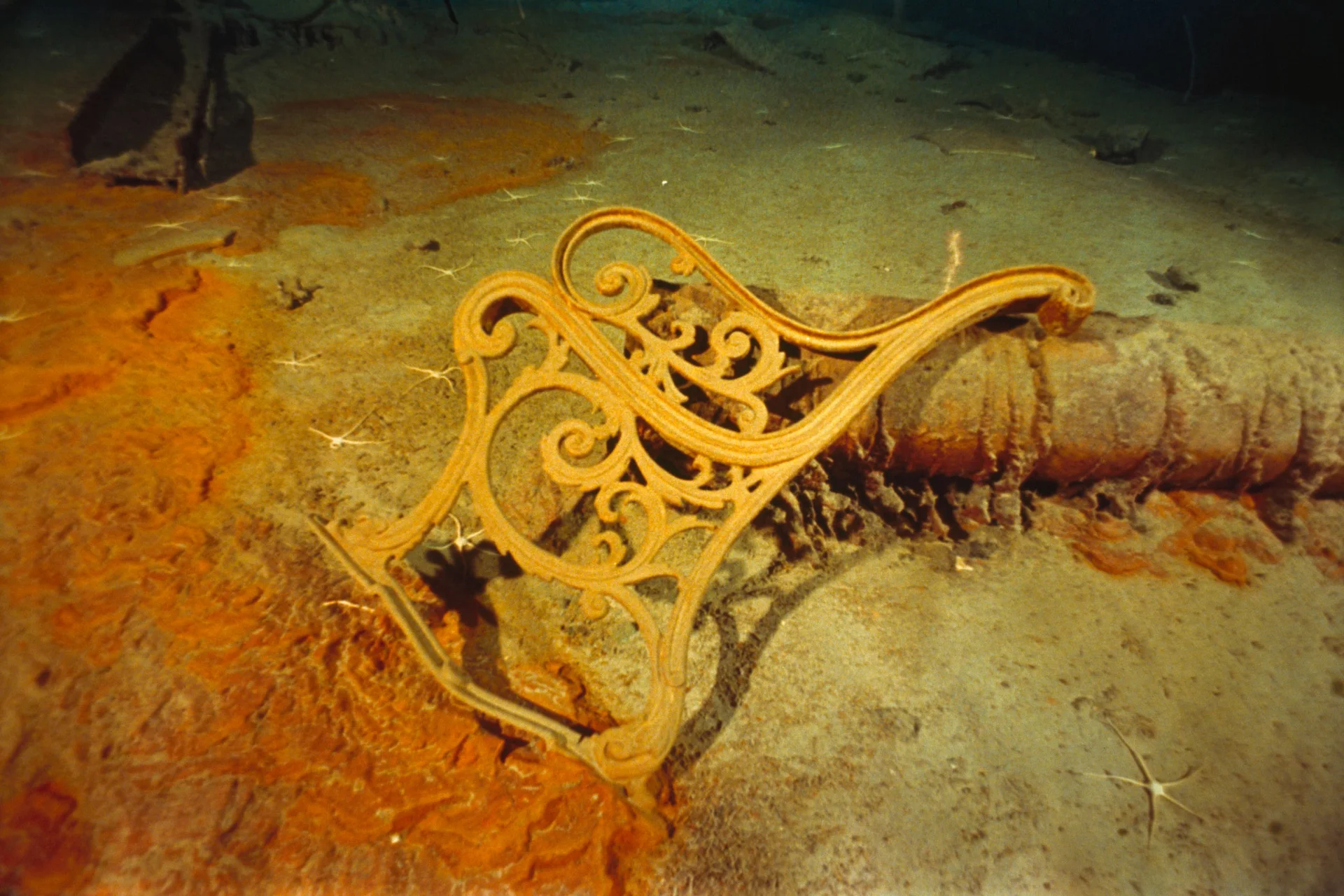 An ornate metal fitting resting on the seabed at Titanic’s wreck